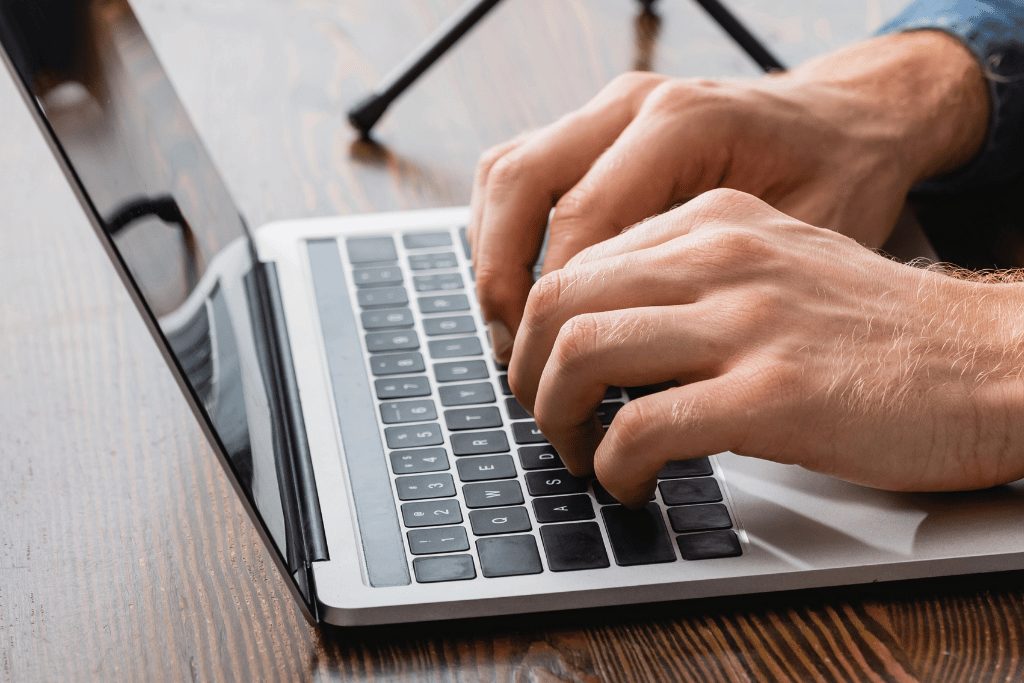 male hands on a laptop keyboard