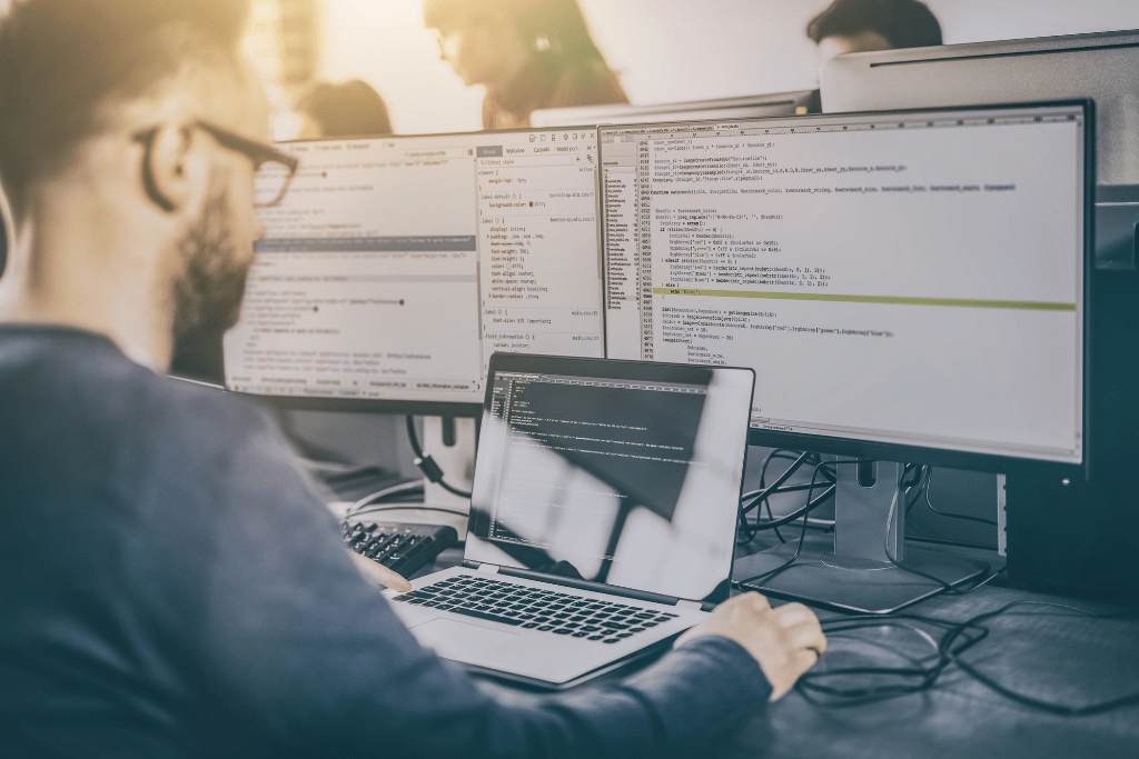man working on the backend of a website on a laptop
