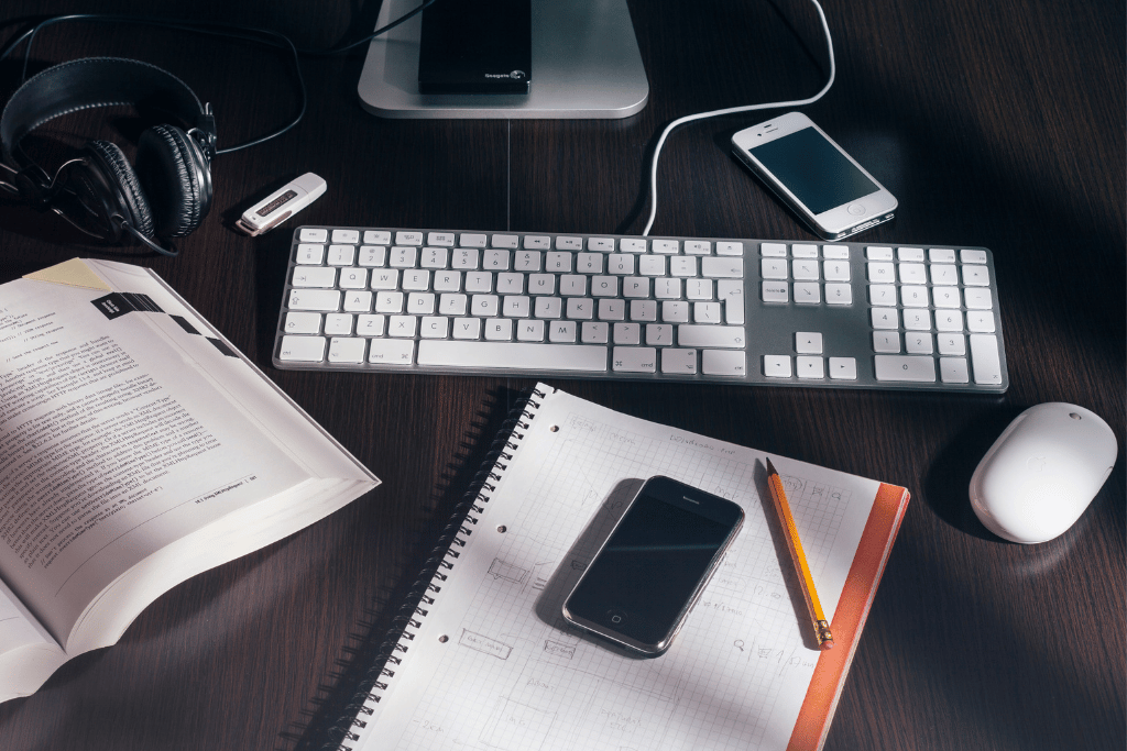 Notepad, mouse, keyboard and book